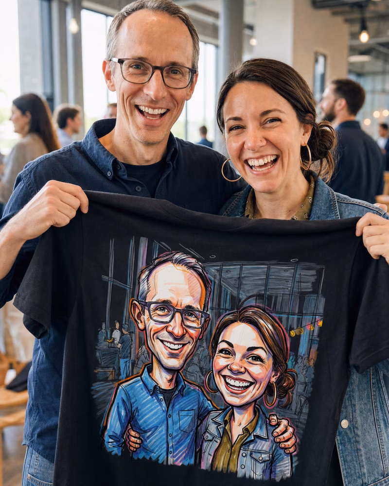 Two coworkers holding up a T-shirt printed with their caricature
